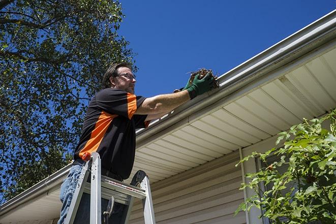 gutter repairman fixing a leaky drain in Arcanum