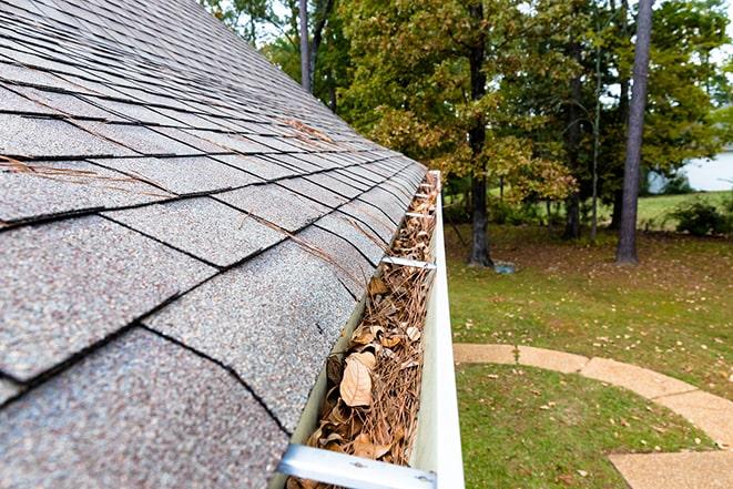 leaves and debris being removed from gutters